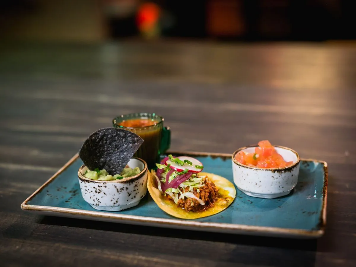 Tacos with sauces on a blue tray